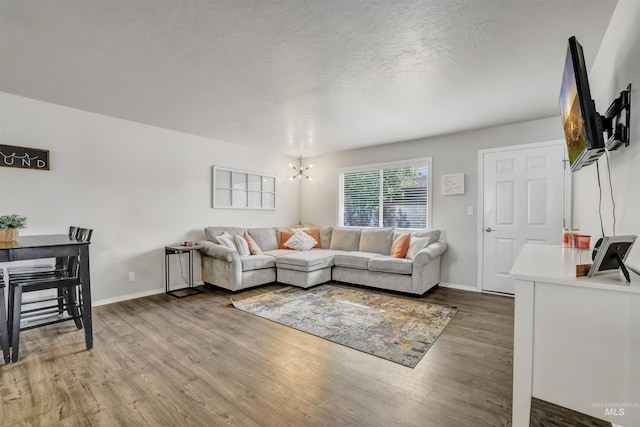 275 Elaine Ave Unit 2, Twin Falls, ID 83301 - living room with wood finished floors, a chandelier, baseboards, and a textured ceiling