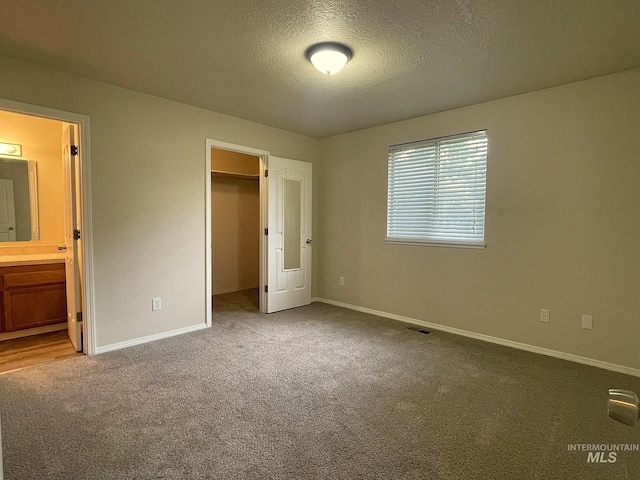 228 W Winnipeg St, Meridian, ID 83642 - unfurnished bedroom featuring carpet floors, baseboards, a spacious closet, a textured ceiling, and a closet