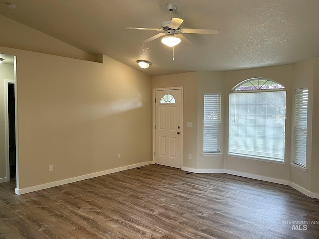 228 W Winnipeg St, Meridian, ID 83642 - foyer featuring dark wood-style floors, ceiling fan, vaulted ceiling, and baseboards