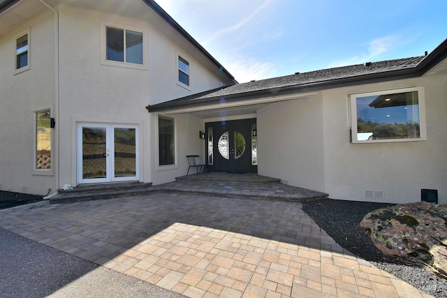 back of house featuring a patio, stucco siding, and visible vents