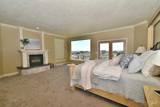 bedroom featuring crown molding, a fireplace, a textured ceiling, carpet floors, and french doors