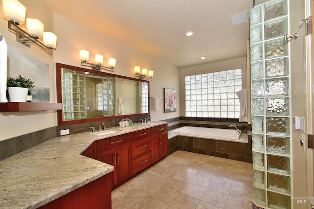 full bathroom featuring a sink, double vanity, recessed lighting, tile patterned floors, and a garden tub