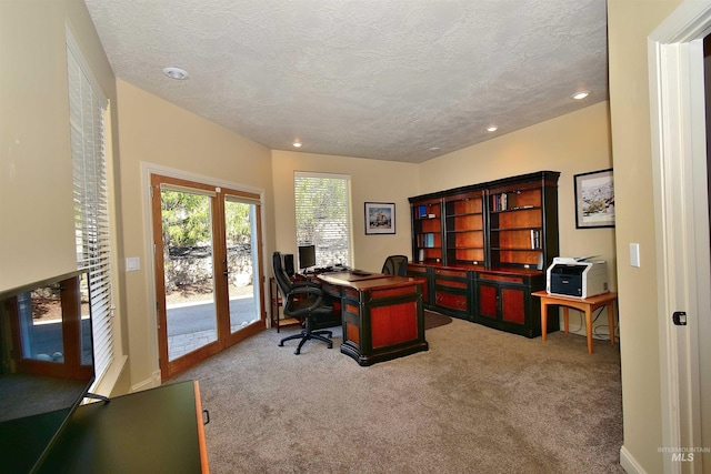 carpeted office with a textured ceiling, french doors, and recessed lighting