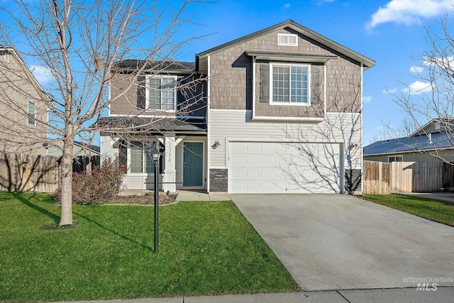 view of property featuring a front yard and a garage