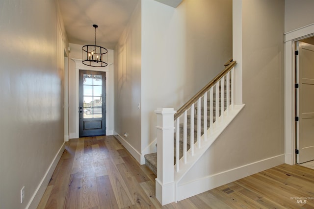 entrance foyer featuring light hardwood / wood-style flooring and a chandelier