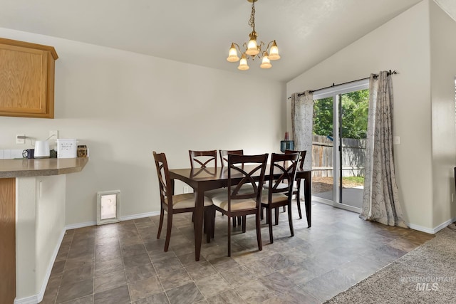 3719 E Sandyford Ave, Nampa, ID 83686 - dining room featuring a chandelier, vaulted ceiling, and stone finish flooring