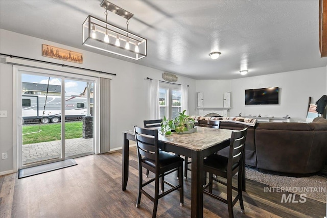 1430 NE Quigley St, Mountain Home, ID 83647 - dining space with a textured ceiling, wood finished floors, and baseboards