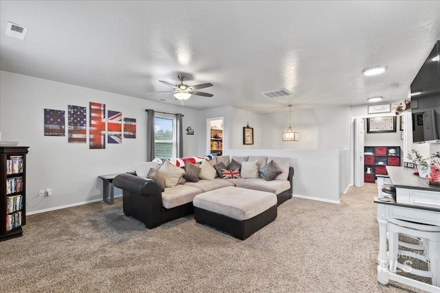 1430 NE Quigley St, Mountain Home, ID 83647 - carpeted living area with visible vents, baseboards, and a ceiling fan