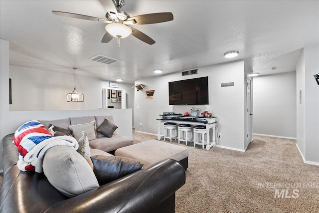 1430 NE Quigley St, Mountain Home, ID 83647 - living room with visible vents, ceiling fan, baseboards, and carpet floors