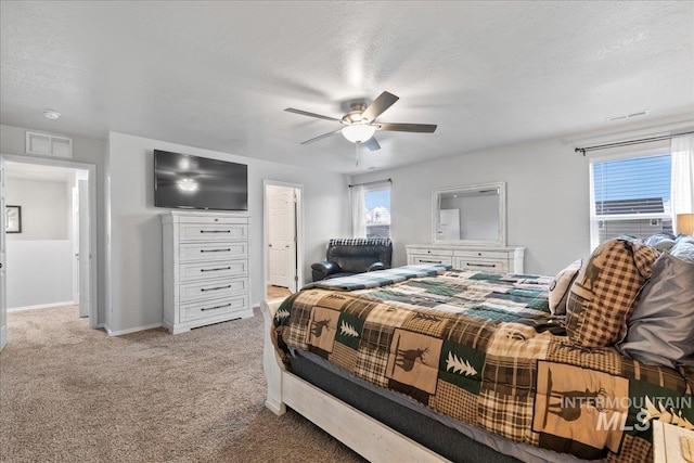 1430 NE Quigley St, Mountain Home, ID 83647 - bedroom with baseboards, light colored carpet, ceiling fan, and visible vents