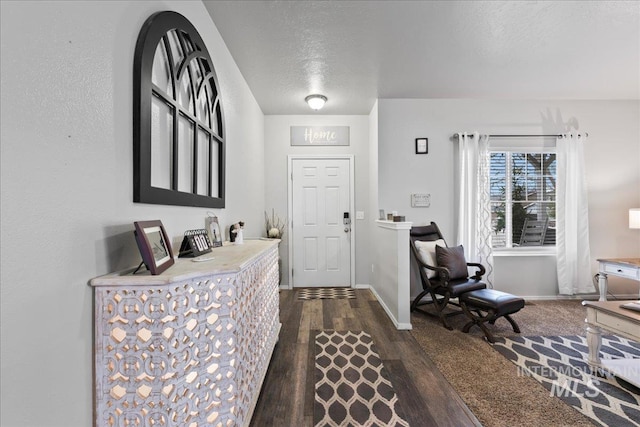 1430 NE Quigley St, Mountain Home, ID 83647 - entryway featuring dark wood-type flooring, baseboards, and a textured ceiling
