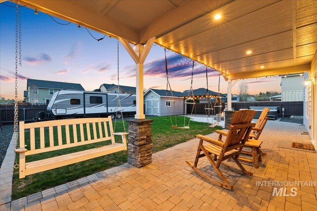 1430 NE Quigley St, Mountain Home, ID 83647 - view of patio / terrace with a fenced backyard, an outdoor structure, and a shed
