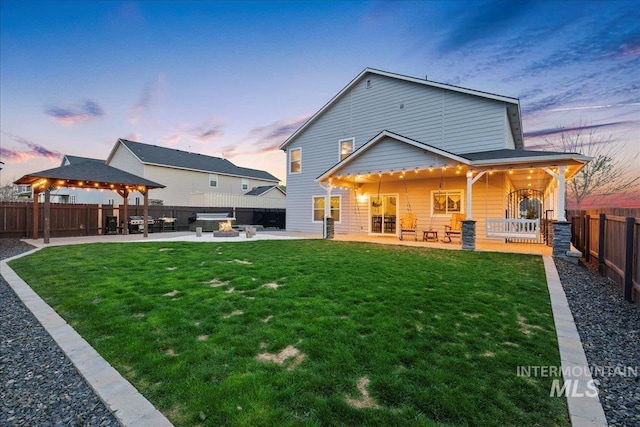 1430 NE Quigley St, Mountain Home, ID 83647 - back of property featuring a yard, a patio area, a fenced backyard, and a gazebo