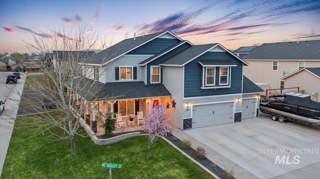 1430 NE Quigley St, Mountain Home, ID 83647 - view of front of property featuring a yard, driveway, a porch, and a garage