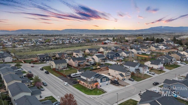 1430 NE Quigley St, Mountain Home, ID 83647 - aerial view at dusk featuring a mountain view and a residential view