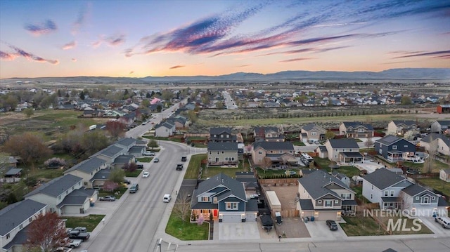 1430 NE Quigley St, Mountain Home, ID 83647 - aerial view at dusk with a mountain view and a residential view