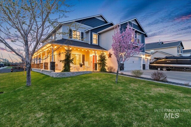 1430 NE Quigley St, Mountain Home, ID 83647 - craftsman-style home featuring a garage, driveway, and a front lawn