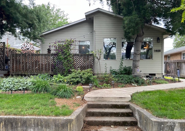 bungalow-style house with fence