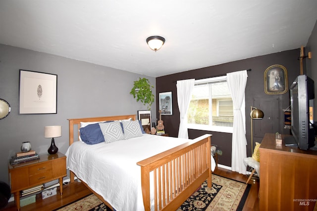 bedroom with wood finished floors