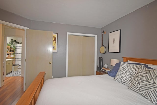 bedroom with a closet and wood finished floors