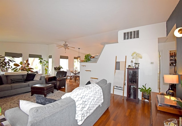 living room with visible vents, wood finished floors, wine cooler, ceiling fan, and vaulted ceiling