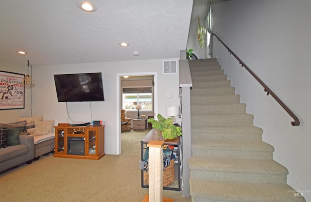 staircase with recessed lighting, visible vents, and carpet flooring