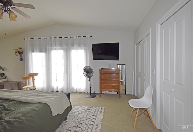 bedroom with lofted ceiling, carpet floors, and a ceiling fan