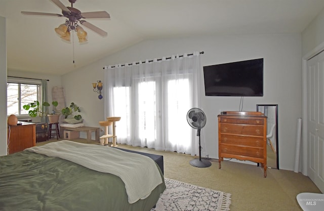 bedroom featuring carpet floors, lofted ceiling, and ceiling fan