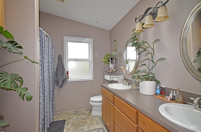 full bath with double vanity, toilet, lofted ceiling, and a sink