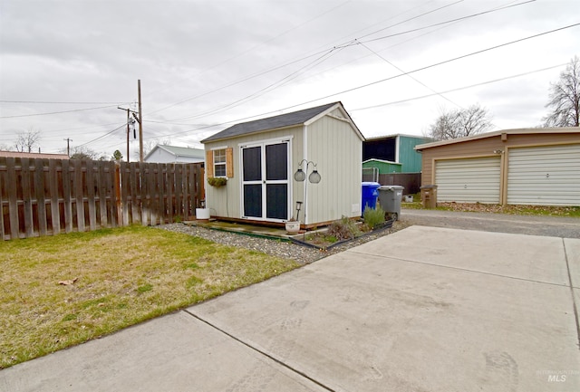 view of outbuilding featuring an outdoor structure and fence