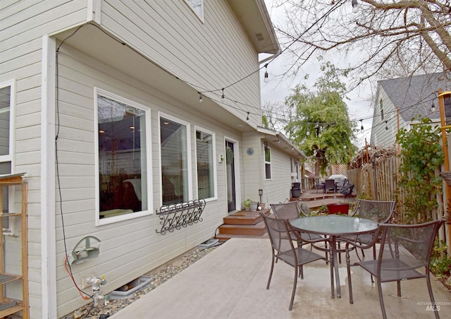 view of patio / terrace featuring outdoor dining area and fence