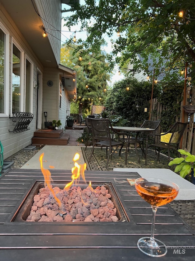 deck featuring outdoor dining area and an outdoor fire pit