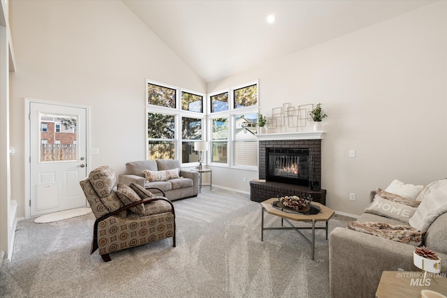 carpeted living area featuring a fireplace, baseboards, and high vaulted ceiling