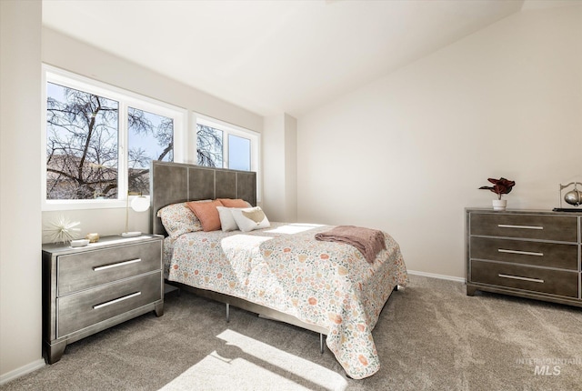 bedroom featuring baseboards, carpet floors, and lofted ceiling