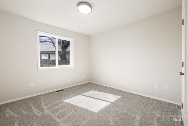 spare room featuring visible vents, baseboards, and carpet flooring