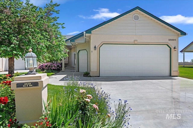 25090 The Driving Ln, Caldwell, ID 83607 - single story home featuring driveway, a garage, and stucco siding