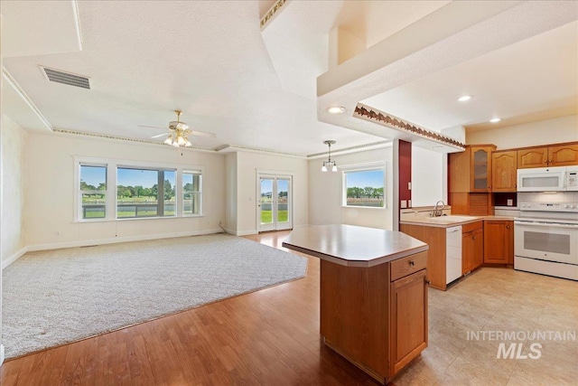 25090 The Driving Ln, Caldwell, ID 83607 - kitchen with white appliances, plenty of natural light, light countertops, open floor plan, and recessed lighting