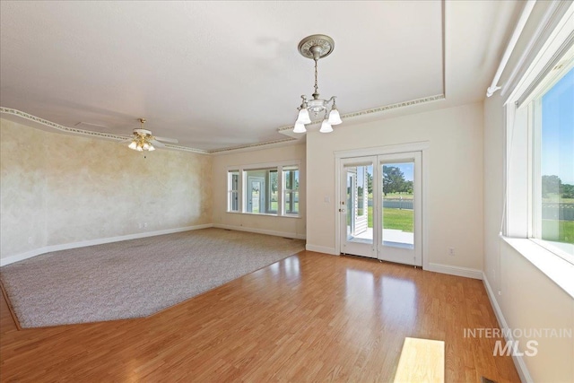 25090 The Driving Ln, Caldwell, ID 83607 - unfurnished room with light wood-style floors, a chandelier, and a ceiling fan