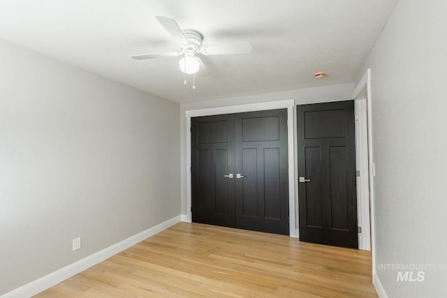 unfurnished bedroom with a closet, ceiling fan, and light hardwood / wood-style flooring