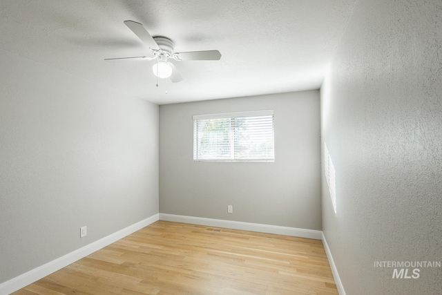 unfurnished room with ceiling fan and light hardwood / wood-style flooring