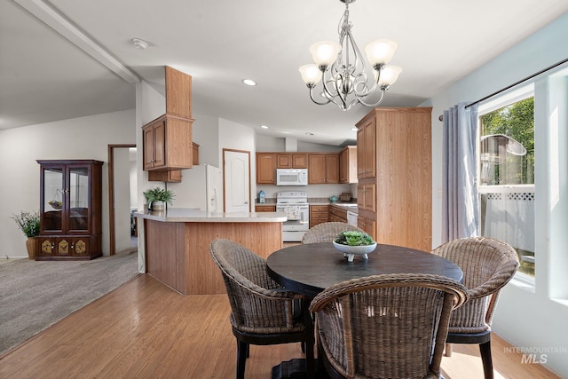 1320 American Ln, Emmett, ID 83617 - dining room with lofted ceiling, a chandelier, light wood-type flooring, and recessed lighting