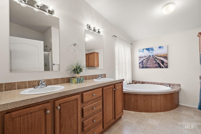 1320 American Ln, Emmett, ID 83617 - bathroom featuring vaulted ceiling, double vanity, a garden tub, a shower with shower door, and tile patterned flooring