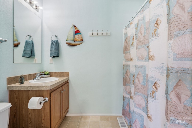 1320 American Ln, Emmett, ID 83617 - bathroom featuring vanity, toilet, tile patterned floors, baseboards, and curtained shower