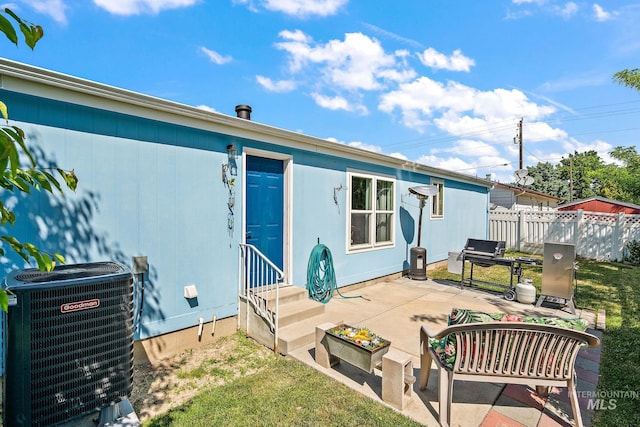 1320 American Ln, Emmett, ID 83617 - back of property with entry steps, central AC, and a patio area