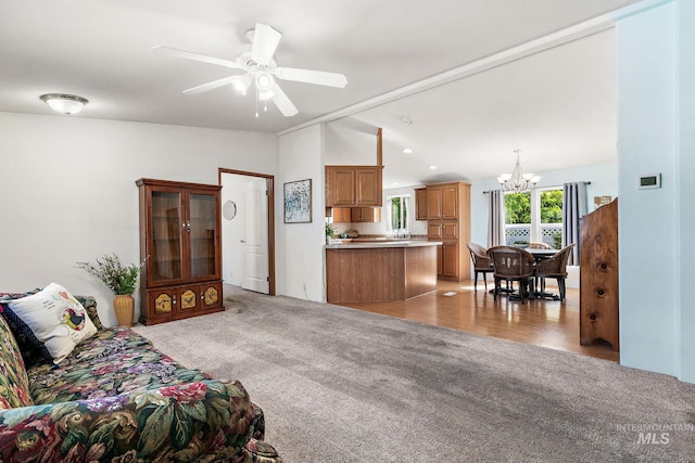 1320 American Ln, Emmett, ID 83617 - living room with light colored carpet, a chandelier, ceiling fan, and vaulted ceiling