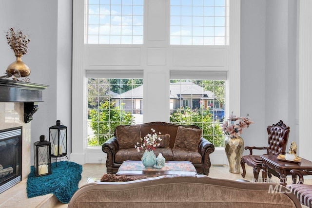 living room featuring a towering ceiling and a wealth of natural light