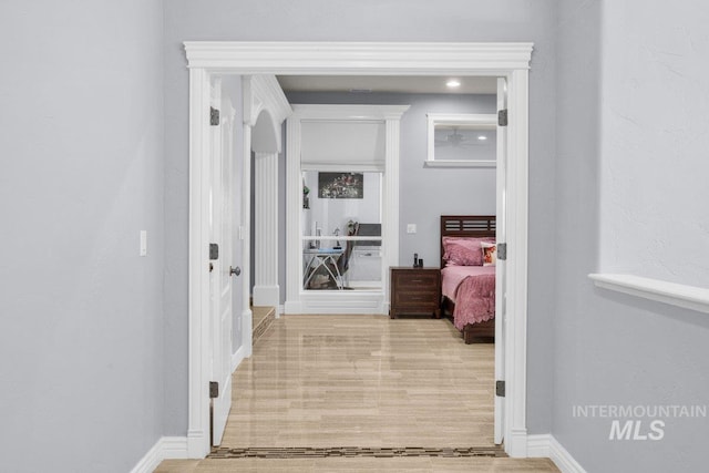 corridor with light wood-type flooring