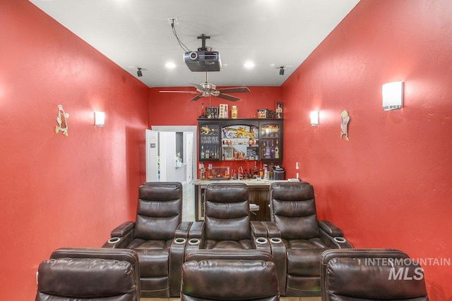 cinema featuring ceiling fan and bar area