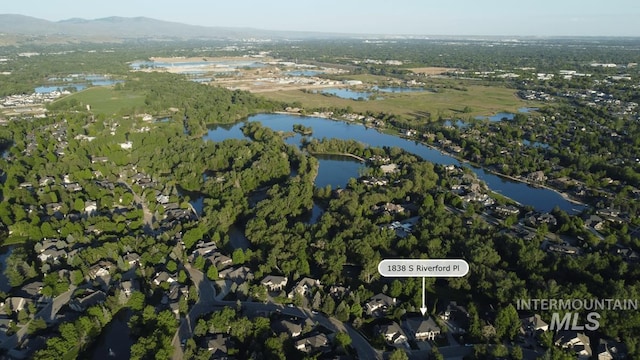 birds eye view of property with a water and mountain view