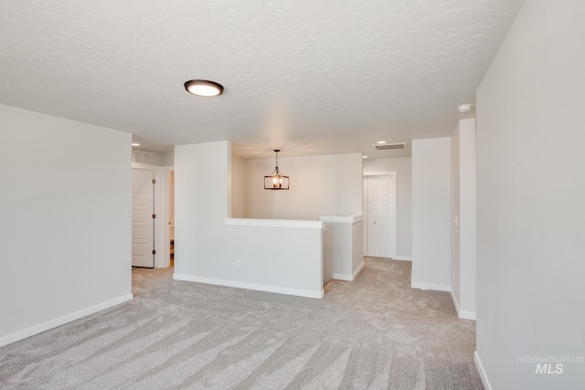 unfurnished room with light colored carpet, visible vents, and baseboards